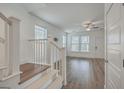 Well-lit living room with hardwood floors, white walls, and a staircase at 219 Clearblue Loop, Summerville, SC 29486