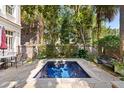 Inviting backyard pool area with a patio table and chairs, perfect for outdoor relaxation at 23 Elliott St, Charleston, SC 29401