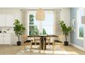 Elegant dining room with a large window, stylish light fixture, and seating for six, perfect for Gathering dinners at 233 Denham St, Summerville, SC 29486