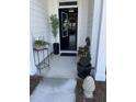 Inviting front porch adorned with seasonal plants and elegant decor at 236 River Martin Ct, Summerville, SC 29483