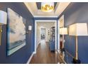 Hallway featuring hardwood floors, stylish lighting, and elegant decor at 236 River Martin Ct, Summerville, SC 29483