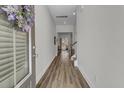 Bright hallway with wood-look flooring and white walls, leading to the rest of the home at 3066 Emma Ln, Mount Pleasant, SC 29466