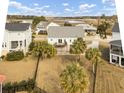 Aerial view of a home featuring a backyard with palm trees, a deck, and a fenced-in yard at 4258 Jacobs Pt Ct, Ravenel, SC 29470