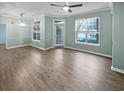 Spacious, light-filled living area with wood floors, large windows, crown molding, and access to the balcony at 45 Sycamore Ave # 1413, Charleston, SC 29407