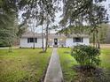 Charming front exterior with a well-manicured lawn and mature landscaping at 488 Society Rd # A&B, McClellanville, SC 29458