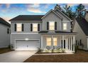 Beautiful two-story home featuring a covered porch and attached two-car garage at 491 Richfield Way, Summerville, SC 29486