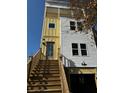 Stylish three-story home featuring an inviting entrance staircase and attached garage at 515 Joseph St, Charleston, SC 29412