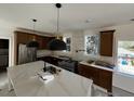 Modern kitchen with dark cabinetry, stainless steel appliances, and a large marble island at 515 Joseph St, Charleston, SC 29412