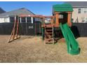 Backyard playground with a slide and swings, perfect for outdoor fun and entertainment at 619 Ravens Wood Rd, Summerville, SC 29486