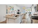 A kitchen island with granite countertop looks out over the dining area at 1004 Lovebug Ln, Summerville, SC 29485