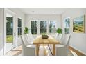Bright dining room features large windows, a light wood table, and seating for six with neutral walls and flooring at 1004 Tulip Shell, Summerville, SC 29485