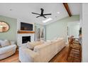 Bright living room with fireplace, skylight, ceiling fan, and access to the backyard at 115 Ridge Rd, Summerville, SC 29485