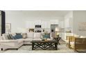 Open-concept living room with an adjacent modern kitchen and decorative accents at 1154 Darling St, Summerville, SC 29485