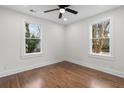 Clean bedroom with hardwood floors, ceiling fan and two windows offering plenty of light at 1226 Pickens St, Hanahan, SC 29410