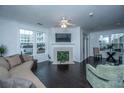 Bright living room featuring a fireplace, hardwood floors, and ample natural light from large windows at 130 River Landing Dr # 7123, Charleston, SC 29492