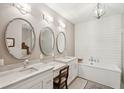 Spa-like bathroom featuring double vanities, soaking tub, and elegant fixtures at 136 Fair Sailing Rd, Mount Pleasant, SC 29466