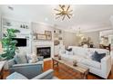 Bright living room featuring a fireplace, built-in shelves, hardwood floors, and stylish decor at 136 Fair Sailing Rd, Mount Pleasant, SC 29466