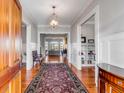 Elegant foyer showcasing hardwood floors, classic trim, and a view into the living area at 1444 Madison Ct, Mount Pleasant, SC 29466