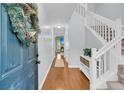 Inviting foyer featuring hardwood floors, a staircase, and stylish decor at 174 Dorothy Dr, Charleston, SC 29414