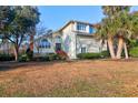 Traditional two-story home with a neatly manicured front lawn and mature tree at 1784 Omni Blvd, Mount Pleasant, SC 29466