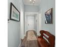 Bright hallway with wood floors, neutral paint, and stylish decor at 2006 Barn Swallow Rd, Summerville, SC 29483