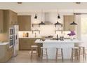 Bright kitchen with stainless steel appliances, a large center island with seating, and stylish pendant lighting at 2010 Mcguire Ln # 003, Hollywood, SC 29449