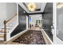 Stunning foyer featuring dark walls, hardwood floors, a modern light fixture, and an open view to the living area at 229 Celestial Blvd, Summerville, SC 29486
