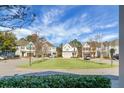 Well-manicured community street view with beautiful homes and a lush green roundabout at 2345 Primus Rd, Mount Pleasant, SC 29466