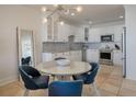 Cozy kitchen with white cabinets, stainless steel appliances, and a stylish backsplash at 2473 Shipwatch Rd, Kiawah Island, SC 29455