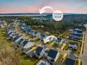 Aerial view of a community near the Stono River with similar home styles and manicured lawns at 2710 Mcfadden Way, Johns Island, SC 29455