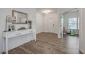 Bright foyer with wood flooring, stylish console table, and view into adjacent room at 428 Avocet Dr, Summerville, SC 29486