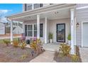 Inviting front porch featuring rocking chairs and decorative plants enhancing curb appeal at 428 Avocet Dr, Summerville, SC 29486