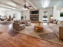 Inviting living room with hardwood floors, a brick fireplace, and plenty of natural light at 503 Middleton Blvd, Summerville, SC 29485