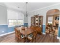 Formal dining room with a large window, wainscotting, and a chandelier over the wood table at 7217 Mossy Creek Ln, Hanahan, SC 29410