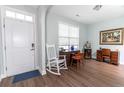 Inviting foyer area featuring hardwood floors, fresh white paint, and a rocking chair to greet guests at 7217 Mossy Creek Ln, Hanahan, SC 29410