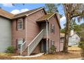 Charming two-story condo featuring wood siding, a private entrance with stairs, and well-maintained landscaping at 7921 Cricket Ct # G, North Charleston, SC 29418