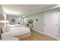 Bedroom with two beds, TV and view into bathroom with toilet and sink at 1126 Ocean Blvd # 203, Isle of Palms, SC 29451
