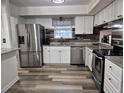 Modern kitchen with stainless steel appliances, granite countertops, and ample cabinet space for storage at 113 Ford Ct, Summerville, SC 29483