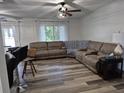 Spacious living room with neutral tones and a large sectional sofa, ideal for relaxing and entertaining guests at 113 Ford Ct, Summerville, SC 29483