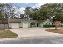 Inviting home with a well-kept lawn, a two-car garage, and a basketball hoop in the driveway at 1227 Chuka Ct, Charleston, SC 29412