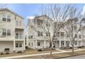 Inviting townhouse exterior featuring a cozy front porch with seating and neat landscaping at 129 Sabal Ct, Summerville, SC 29483