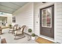 Cozy front porch featuring rocking chairs and view of home's entrance at 129 Sabal Ct, Summerville, SC 29483