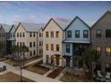 Stylish townhomes featuring varied facades and landscaped front yards, creating inviting curb appeal at 1566 Hancock St # B-1, Mount Pleasant, SC 29464