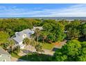 Expansive property offering verdant landscaping, mature trees, and a picturesque backyard at 16 42Nd Ave, Isle of Palms, SC 29451