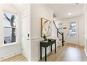 Welcoming foyer with wood floors, decorative accents, and access to the staircase and a naturally lit hall at 1669 Farmers Way, Mount Pleasant, SC 29466