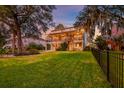 Expansive backyard with lush green lawn, trees, and fence, perfect for outdoor enjoyment at 1756 Indigo Island Dr, Hanahan, SC 29410
