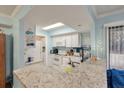 Bright kitchen features granite countertops, white cabinets, and modern appliances under a skylight at 1860 Montclair Dr # 1860-A, Mount Pleasant, SC 29464
