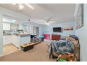 Open-concept living room features cozy seating, a flat-screen TV, and access to a kitchen at 1860 Montclair Dr # 1860-A, Mount Pleasant, SC 29464