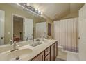 Bright bathroom with a double sink vanity, a large mirror, and a shower with white shower curtain at 2005 Carriage Way, Summerville, SC 29485