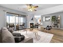Comfortable living room featuring a fireplace, ceiling fan, and sliding doors to the screened-in patio at 208 Greencastle Dr, Goose Creek, SC 29445
